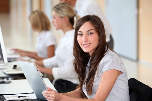 Businesswoman working in the office on electronic pad