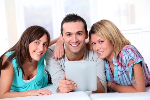Group of friends laying in sofa at home