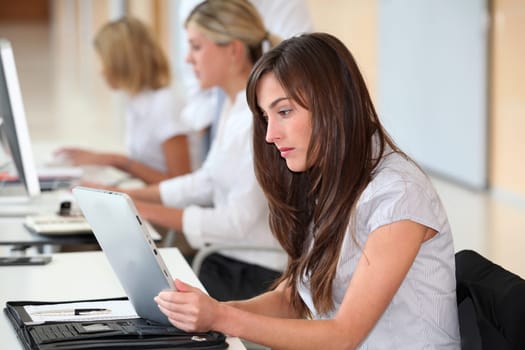 Businesswoman working in the office on electronic pad