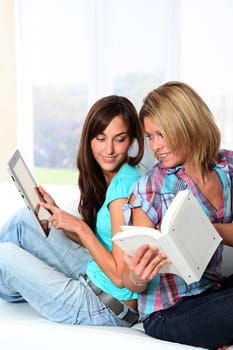 Girlfriends reading book on electronic pad