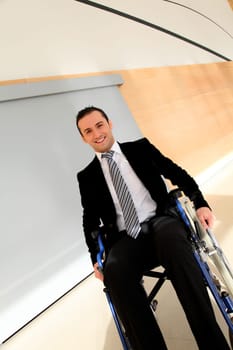 Businessman in wheelchair going to attend congress meeting