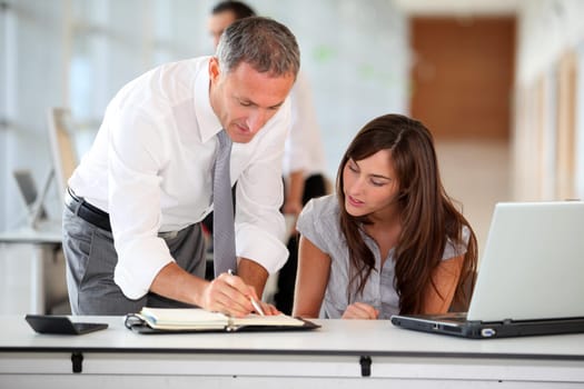 Manager and secretary working in the office