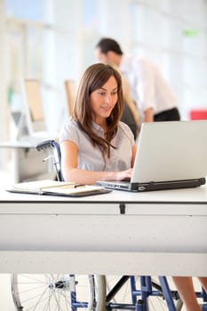 Businesswoman in wheelchair working in the office