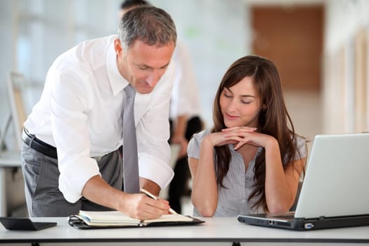 Manager and secretary working in the office