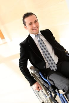 Businessman in wheelchair going to attend congress meeting