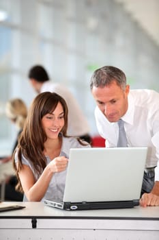 Manager and secretary working in the office