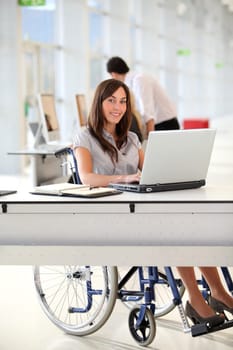 Businesswoman in wheelchair working in the office