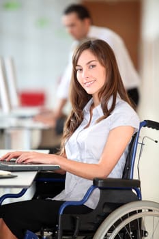 Businesswoman in wheelchair working in the office