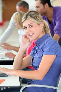 Young blond woman in business training
