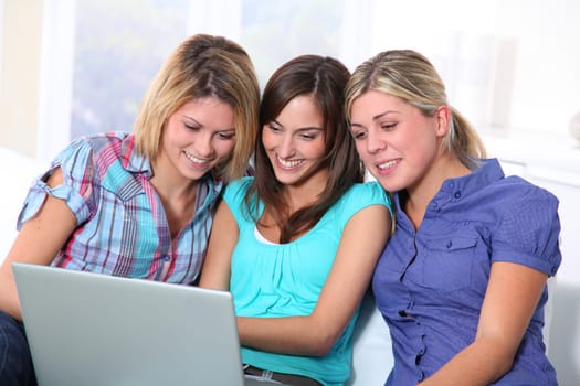 Group of happy girls surfing on internet
