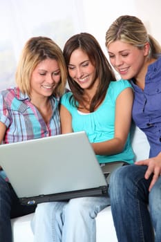 Group of happy girls surfing on internet