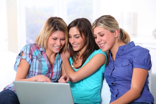 Group of happy girls surfing on internet