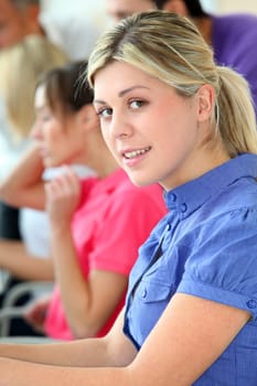 Young blond woman in business training