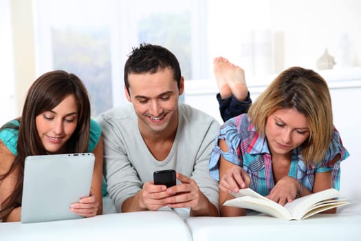 Group of friends laying in sofa at home