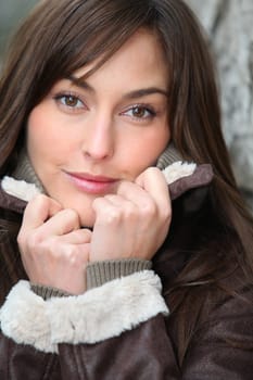 Closeup of beautiful woman with warm jacket in winter