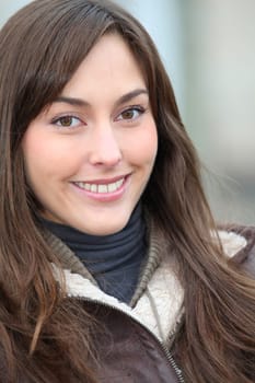 Closeup of beautiful woman with warm jacket in winter