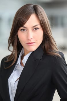 Closeup of beautiful businesswoman standing outside the office