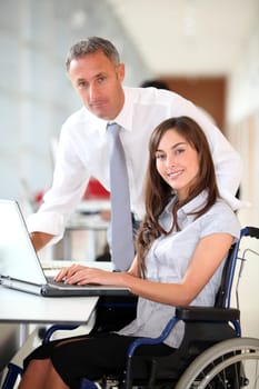 Manager and office worker in wheelchair