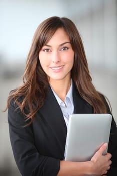 Closeup of beautiful businesswoman with electronic tablet