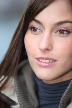 Closeup of beautiful woman with warm jacket in winter