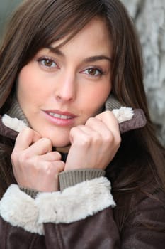 Closeup of beautiful woman with warm jacket in winter