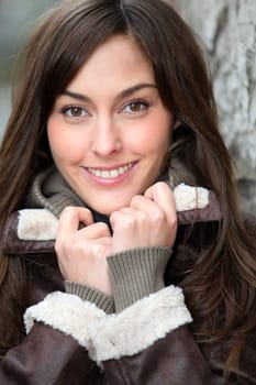 Closeup of beautiful woman with warm jacket in winter