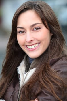 Closeup of beautiful woman with warm jacket in winter