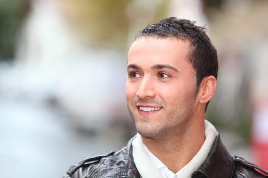 Closeup of man with leather jacket standing outside