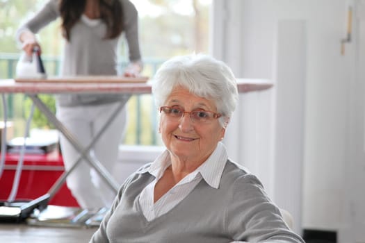 Closeup of elderly woman with home help