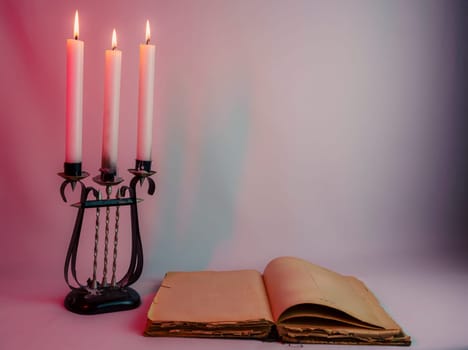 Elegant antique candelabrum with three lit candles, casting a warm glow on a red and purple gradient background. Perfect for romantic, gothic, and vintage-themed designs