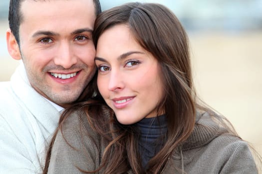 Young couple spending a week-end at the beach in winter