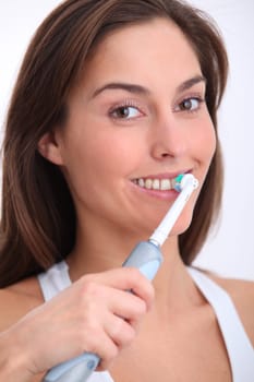 Closeup of beautiful woman brushing her teeth