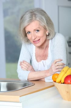 Senior woman standing in kitchen