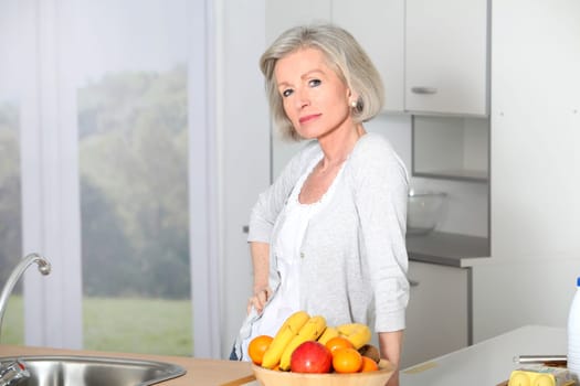 Senior woman standing in kitchen