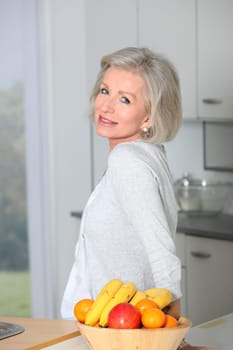 Senior woman standing in kitchen