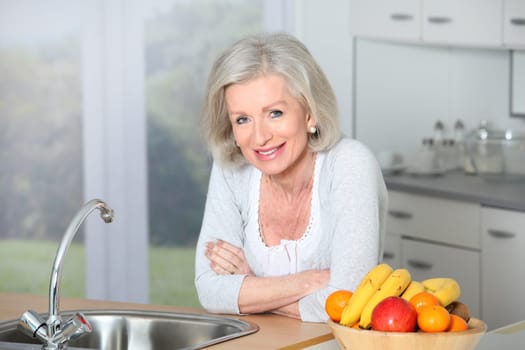 Senior woman standing in kitchen