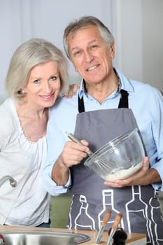 Happy senior couple baking together
