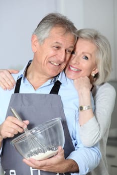 Happy senior couple baking together
