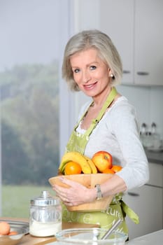 Smiling senior woman in kitchen