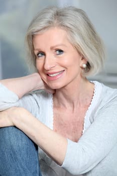Closeup of smiling senior woman relaxing at home