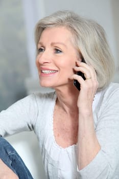 Happy senior woman talking on mobile phone