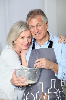Happy senior couple baking together
