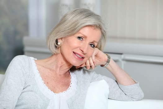 Closeup of smiling senior woman relaxing at home
