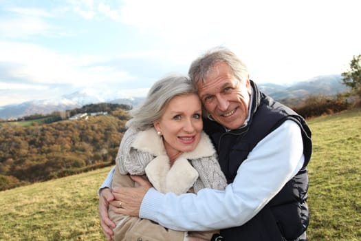 Portrait of happy senior couple in countryside