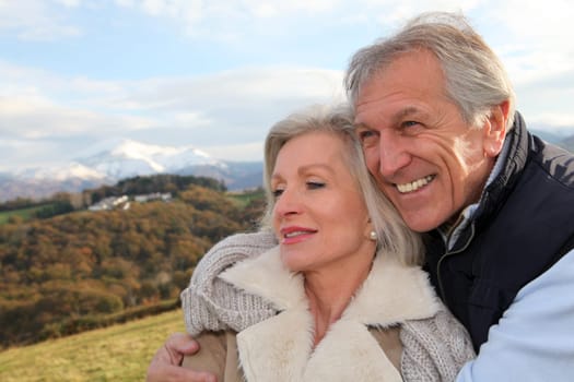 Portrait of happy senior couple in countryside