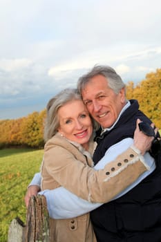 Happy senior couple embracing each other in countryside