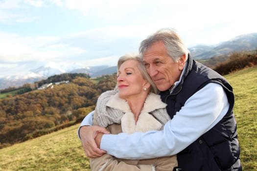 Portrait of happy senior couple in countryside