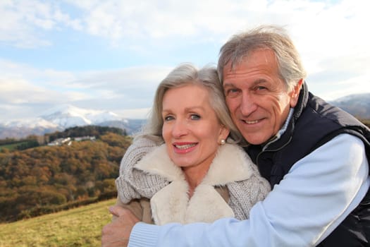 Portrait of happy senior couple in countryside