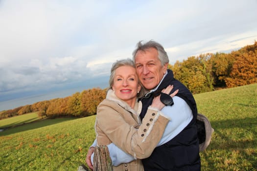 Happy senior couple embracing each other in countryside