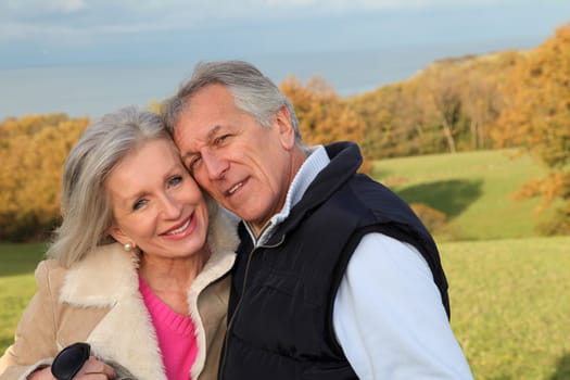 Happy senior couple embracing each other in countryside